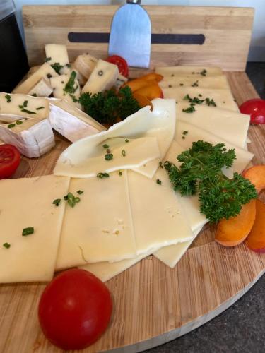 a cutting board with cheese and vegetables on it at Gasthof zum Mohrn in Oberwölz Stadt