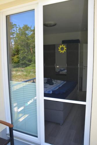 a sliding glass door with a view of a balcony at Ostsee-Karo in Graal-Müritz