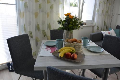 a table with a plate of fruit on it at Ostsee-Karo in Graal-Müritz