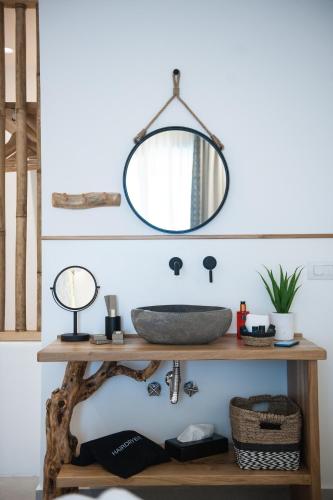 a bathroom with a sink and a mirror at Bohemia Luxury Living in Hanioti