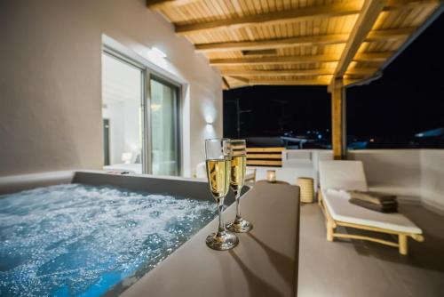 een glas champagne op een tafel naast een bad bij Bohemia Luxury Living in Hanioti