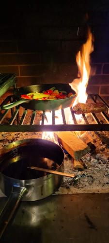 two pans of food are cooking in an oven at Drei Könige in Entlebuch