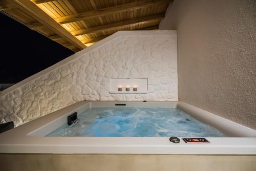 a jacuzzi tub in the corner of a room at Bohemia Luxury Living in Hanioti