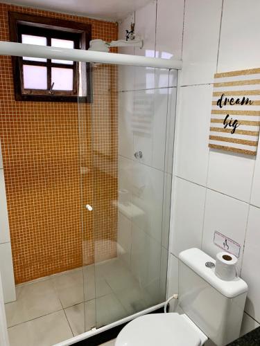 a bathroom with a toilet and a glass shower at Pura Vida Hostel in Rio de Janeiro