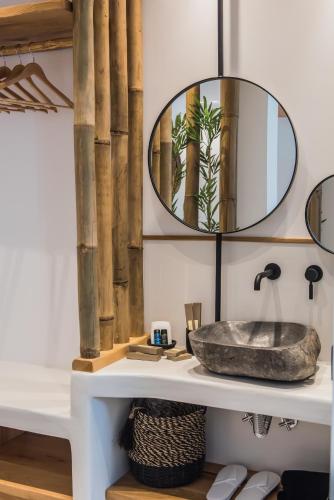 a bathroom with a sink and a mirror at Bohemia Luxury Living in Hanioti