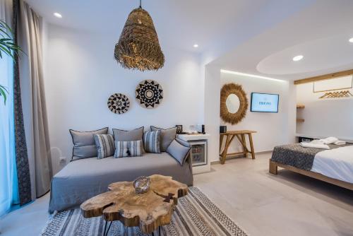 a bedroom with a bed and a table at Bohemia Luxury Living in Hanioti