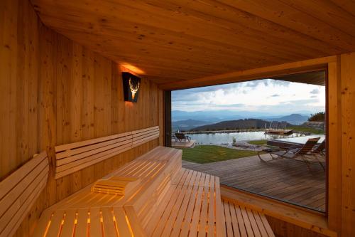 a large window in a wooden cabin with a deck at Gipfelhaus Magdalensberg in Sankt Veit an der Glan