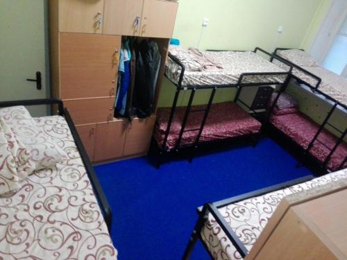 a room with three bunk beds and a blue floor at Future in Kyiv