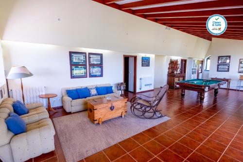 a living room with couches and a pool table at Casas do Termo in Lagoa