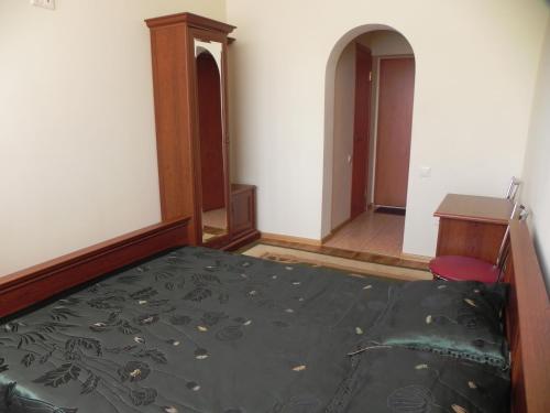 a bedroom with a bed and a desk and a chair at Blaz in Odesa