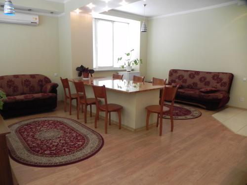 a living room with a table and chairs and a couch at Blaz in Odesa