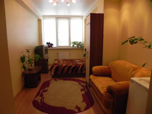 a living room with a bed and a couch at Blaz in Odesa