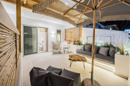 a living room with a couch and a table at Bohemia Luxury Living in Hanioti
