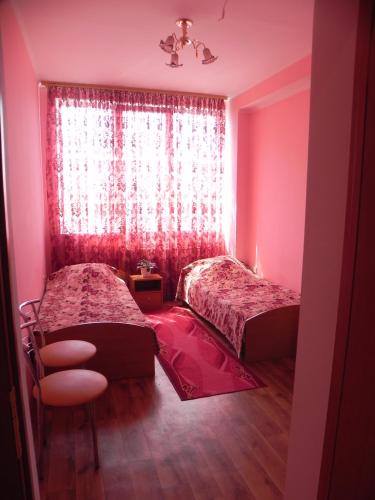 a bedroom with two beds and a window at Blaz in Odesa