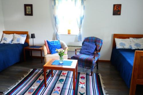 a living room with a couch and a table at Chata na końcu świata in Rzuchowa