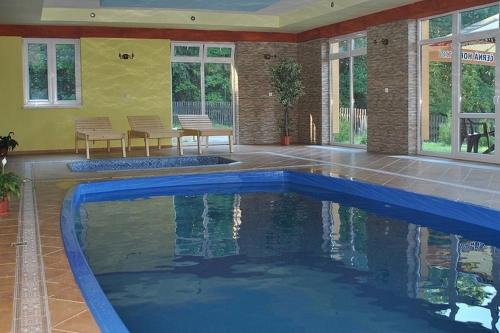 a swimming pool in the middle of a house at Penzion Ustie in Trstená