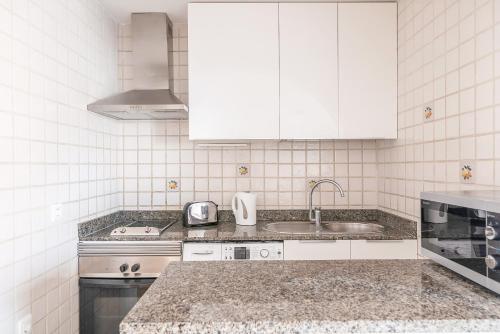 a kitchen with a sink and a counter top at Calas Beach Corralejo in Corralejo