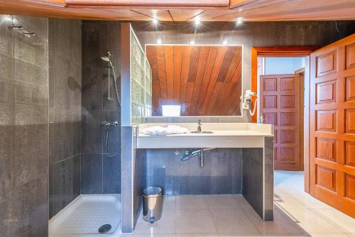 a bathroom with a sink and a shower at Calas Beach Corralejo in Corralejo
