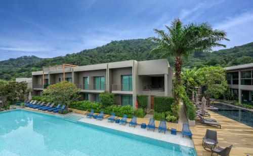 a hotel with a swimming pool and a resort at Fusion Suites Phuket Patong in Patong Beach