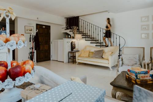 a woman walking down the stairs in a living room at Vincent in Kazimierz Dolny