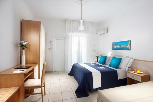 a bedroom with a bed and a desk and a couch at Adriatico Family Village in Gatteo a Mare
