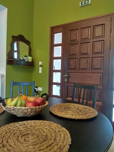 a table with two baskets of fruit on top of it at Emily Villas in Sami
