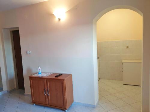 a bathroom with a light on the wall and a cabinet at BetaNovalja in Novalja