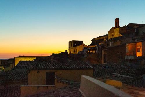 a sunset over the roofs of a city at BnB Sant'Alfonso in Agrigento