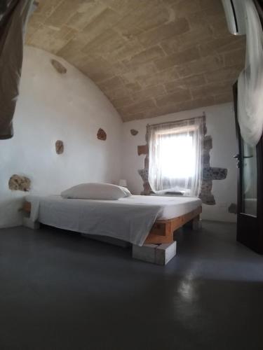Postel nebo postele na pokoji v ubytování La Torre di Merlino