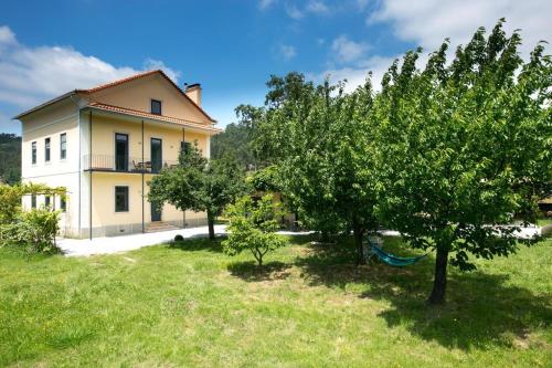 a large house with trees in the yard at Casa Joya in Góis