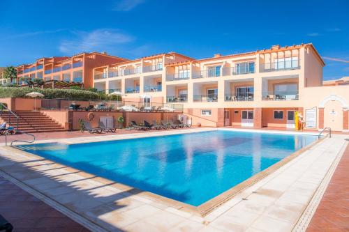 an image of a swimming pool in front of a building at Boavista Golf & Spa - Bela Colina Holidays in Lagos