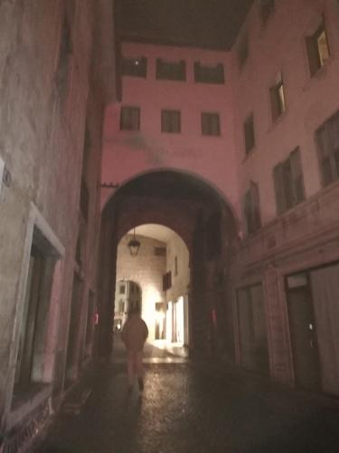 a person walking through an alley in a building at Casetta next to the Creek Sebastiano Ricci in Belluno