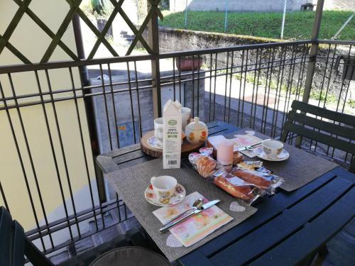 a table with breakfast food on a balcony at Casetta next to the Creek Sebastiano Ricci in Belluno