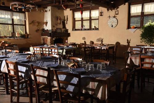 a dining room with tables and chairs with blue tablecloths at IL NIDO DEL FALCO in Pradleves