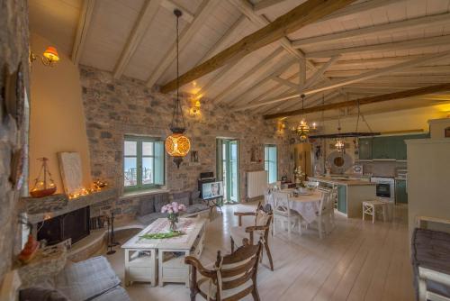 a large living room with a table and a kitchen at Villa Dimitra - Mani , traditional archontiko in Dhirós