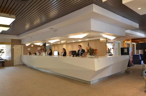 a lobby with a large white counter in a building at Beatriz Toledo Auditorium & Spa in Toledo