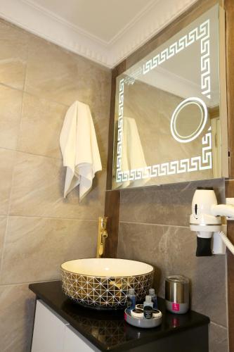a bathroom with a sink and a mirror at Grand Moon Hotel Suites in Istanbul