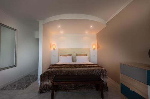 a bedroom with a large bed with white pillows at CORALINE OCEANIC studio vue mer in Portimão