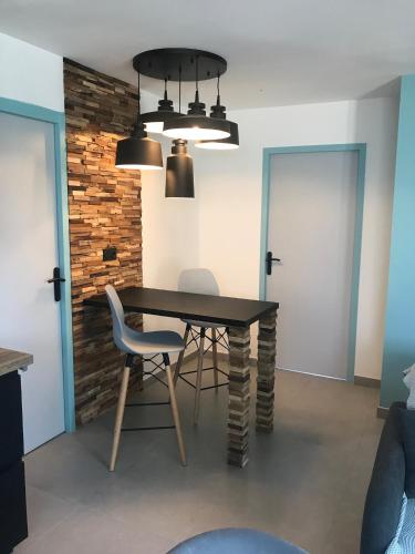 a dining room with a table and two chairs at Jolie Maisonnette Studio in Saint-Herblain