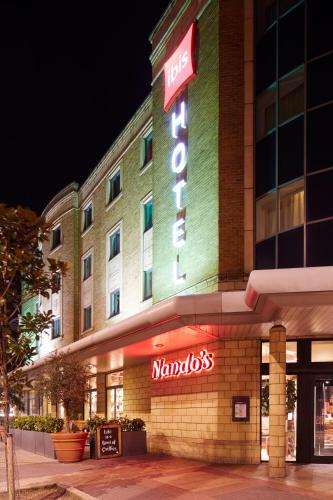a hotel with a sign on the front of it at ibis London Stratford in London
