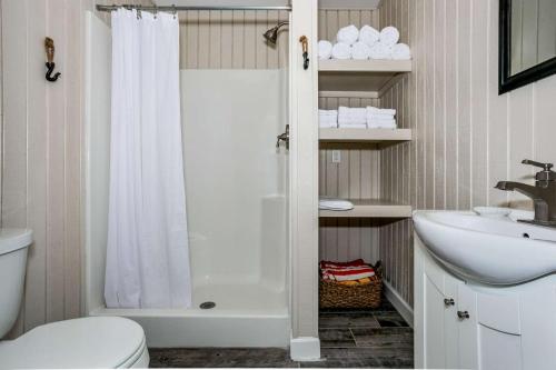 a bathroom with a shower and a toilet and a sink at Lone Palm on the Bayou in Pensacola
