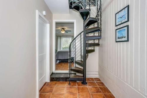 a hallway with a spiral staircase in a home at Lone Palm on the Bayou in Pensacola
