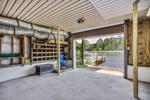 an empty building with a large door and a large window at Lone Palm on the Bayou in Pensacola
