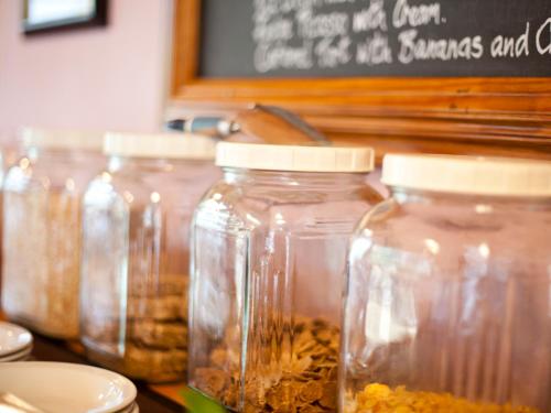 a group of jars of food sitting on a table at Andelomi Forest Lodge in Stormsrivier