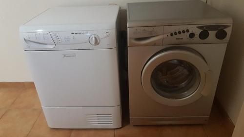 a washer and dryer next to a washing machine at GRAŽINOS SODYBA in Telšiai