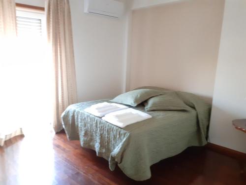 a bedroom with a bed in a room with a window at Casa da Praça in Sertã