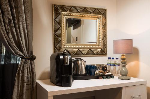 a table with a coffee maker and a mirror at Temple Bar Lane in Dublin