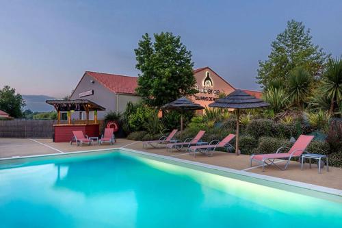 a swimming pool with chairs and umbrellas in front of a house at Best Western Hotel Nuit De Retz Nantes Sud in Port-Saint-Père