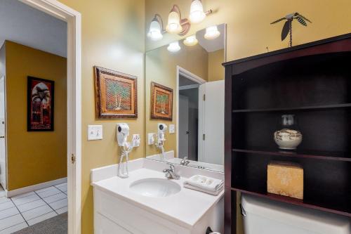 a bathroom with a sink and a mirror at TOPS'L Summit IV in Destin