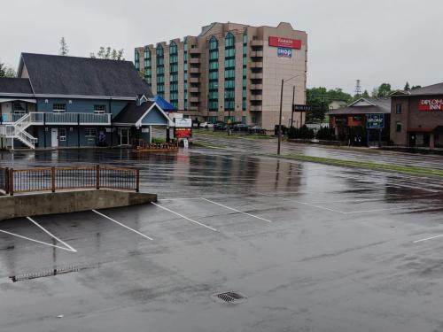 an empty parking lot in a city with a building at Falls Lodge & Suites in Niagara Falls